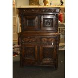 A Victorian 17th century-style oak court cupboard having moulded pediment over florally carved