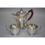 A 20th century silver three piece part coffee set with a conical hot water jug, cream and sugar,