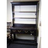 A mid 18th century oak tall dresser, the later rack with moulded cornice and three open shelves, the