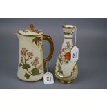 A Royal Worcester jug and cover with floral decoration and faux bamboo handle on an ivory and gilt