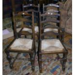 A part set of five reproduction ladder back dining chairs, each with drop-in rush seat, on bobbin