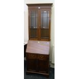 An Edwardian mahogany bureau bookcase, the moulded and dentil cornice above a pair of glazed doors