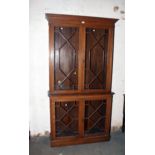 A late 19th century two section oak bookcase, each section with a pair of astragal glazed doors,