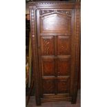 An oak hall cupboard with carved door