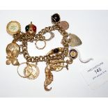 A lady's 9ct gold charm bracelet - 67g