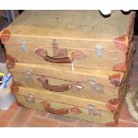 Three vintage leather and canvas suitcases