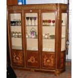 An inlaid French three door display cabinet with g