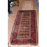 A small Middle Eastern rug with red ground, togeth