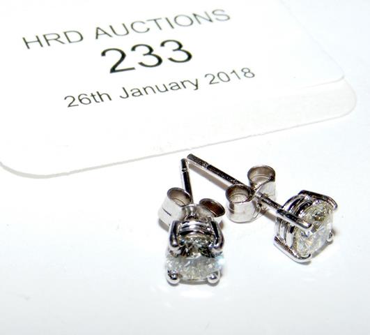 A pair of diamond stud earrings in 18ct white gold