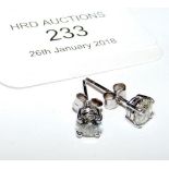 A pair of diamond stud earrings in 18ct white gold