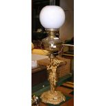 A decorative 80cm high antique oil lamp with figur