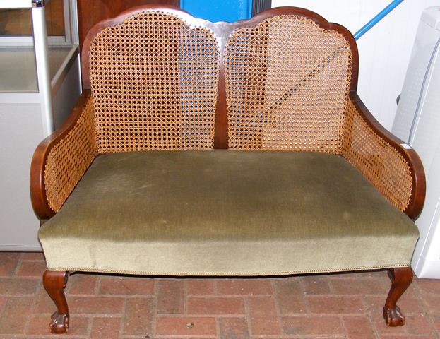 A two seater bergere style settee with cabriole su