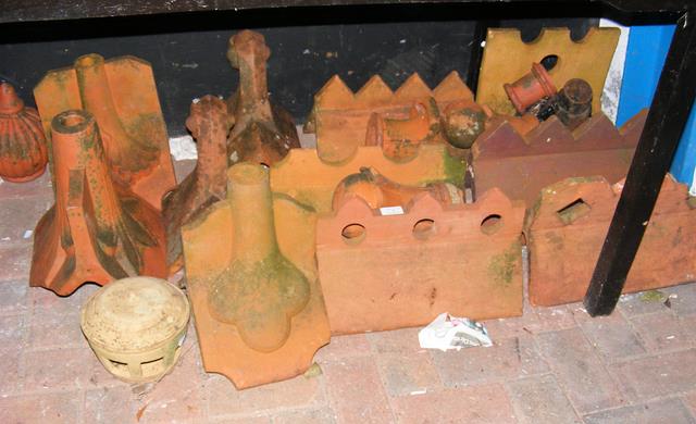 Selection of old terracotta ridge tiles and finial