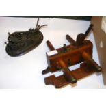 A bronze model of a vintage plough, together with