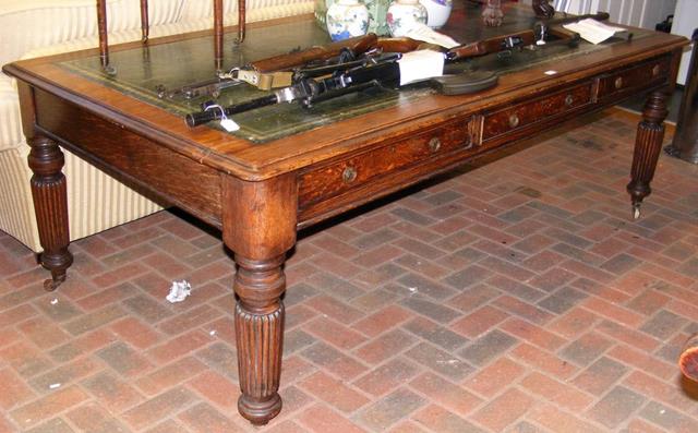 A 19th century oak partner's desk with green leath