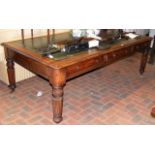 A 19th century oak partner's desk with green leath