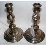 A pair of silver candlesticks - 17cm high