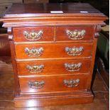 A miniature chest of two short and three long draw