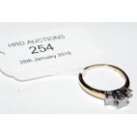 A three stone diamond ring in 14ct gold setting (a