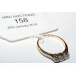 A lady's three stone ring in 18ct gold setting