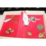 Selection of gold pendants, brooches, etc.