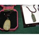 A jade pendant on chain, together with one other