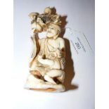 A carved ivory figure of man and mythical child -