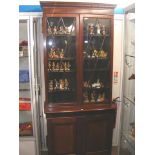 An antique mahogany bookcase with cupboards below