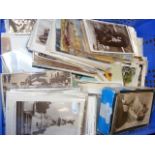 A tray containing various collectable postcards an