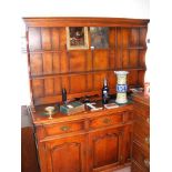 A Georgian style oak dresser with plate rack over