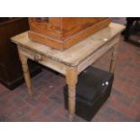 A small antique pine table with single drawer