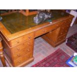 A Victorian oak pedestal desk with green leather t