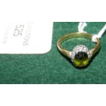 A green stone and diamond ring in gold mount