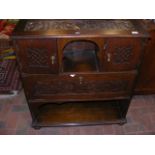 A carved oak side cabinet