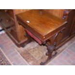 A 19th century work table with shaped under tier