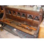 A Gothic oak pew having carved ends - 185cm long