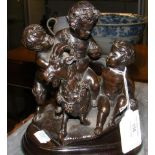 A bronze figural group of cherubs with ram - 17cm