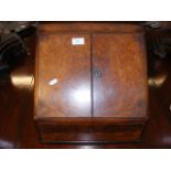 A Victorian walnut stationery box with fitted inte