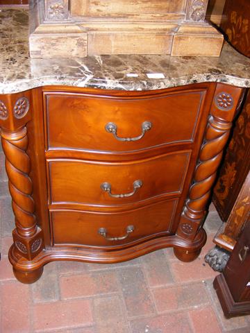 A Victorian style mahogany and marble top three dr