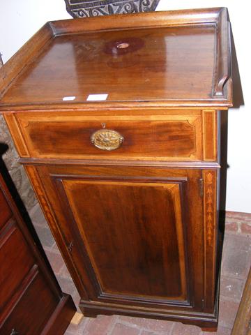 An Edwardian mahogany pot cupboard with drawer to