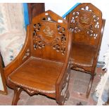 Pair of Gothic style antique hall chairs with shie