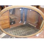 A large 19th century gilt oval wall mirror - 140cm