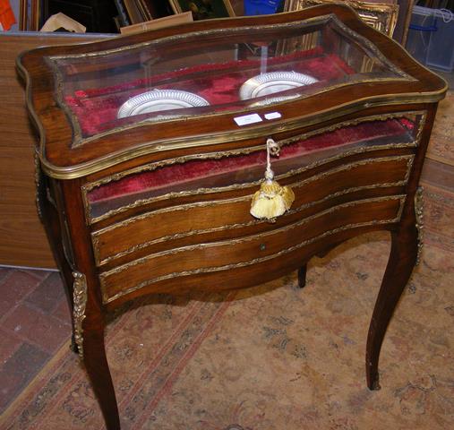 A French antique gilt bound display cabinet on cabriole su