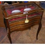 A French antique gilt bound display cabinet on cabriole su