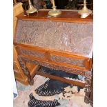 An oriental carved hardwood bureau