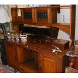 An Arts and Crafts style oak dresser with rack ove