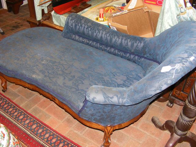 An antique chaise longue on cabriole supports