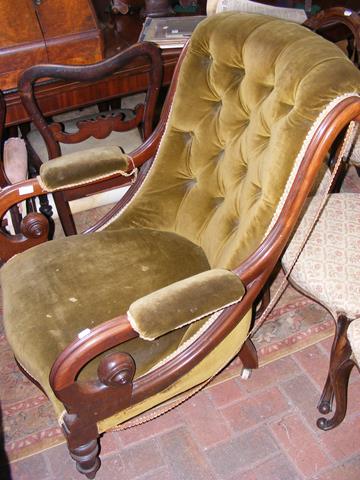 A 19th century button back library chair with scro