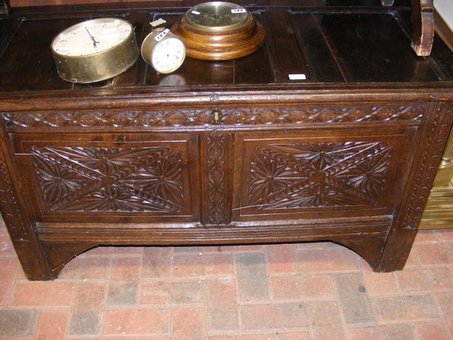 A period oak panelled coffer with carved front