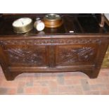 A period oak panelled coffer with carved front